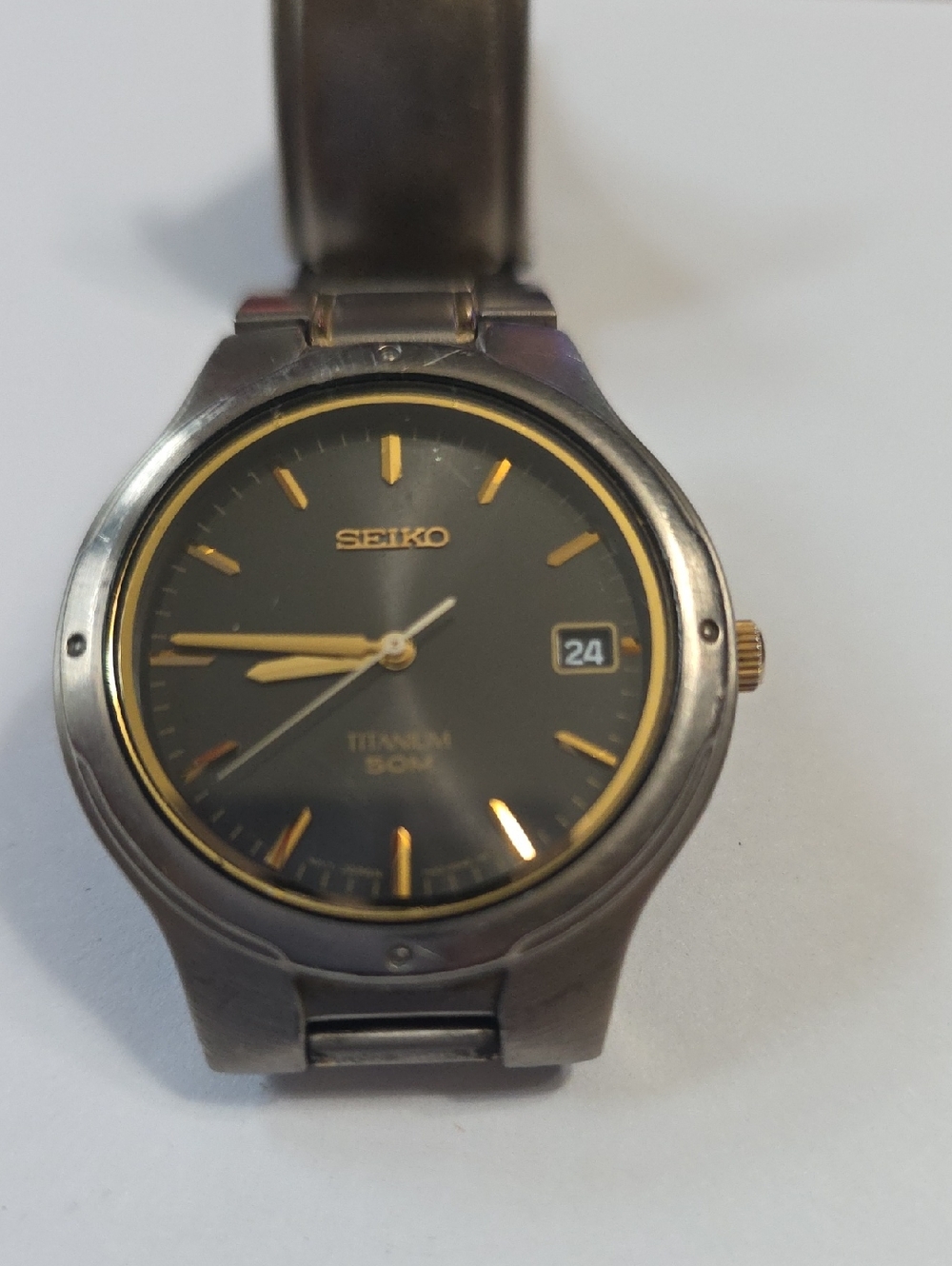 Seiko Titanium Watch with Black Dial and Gold Accents
